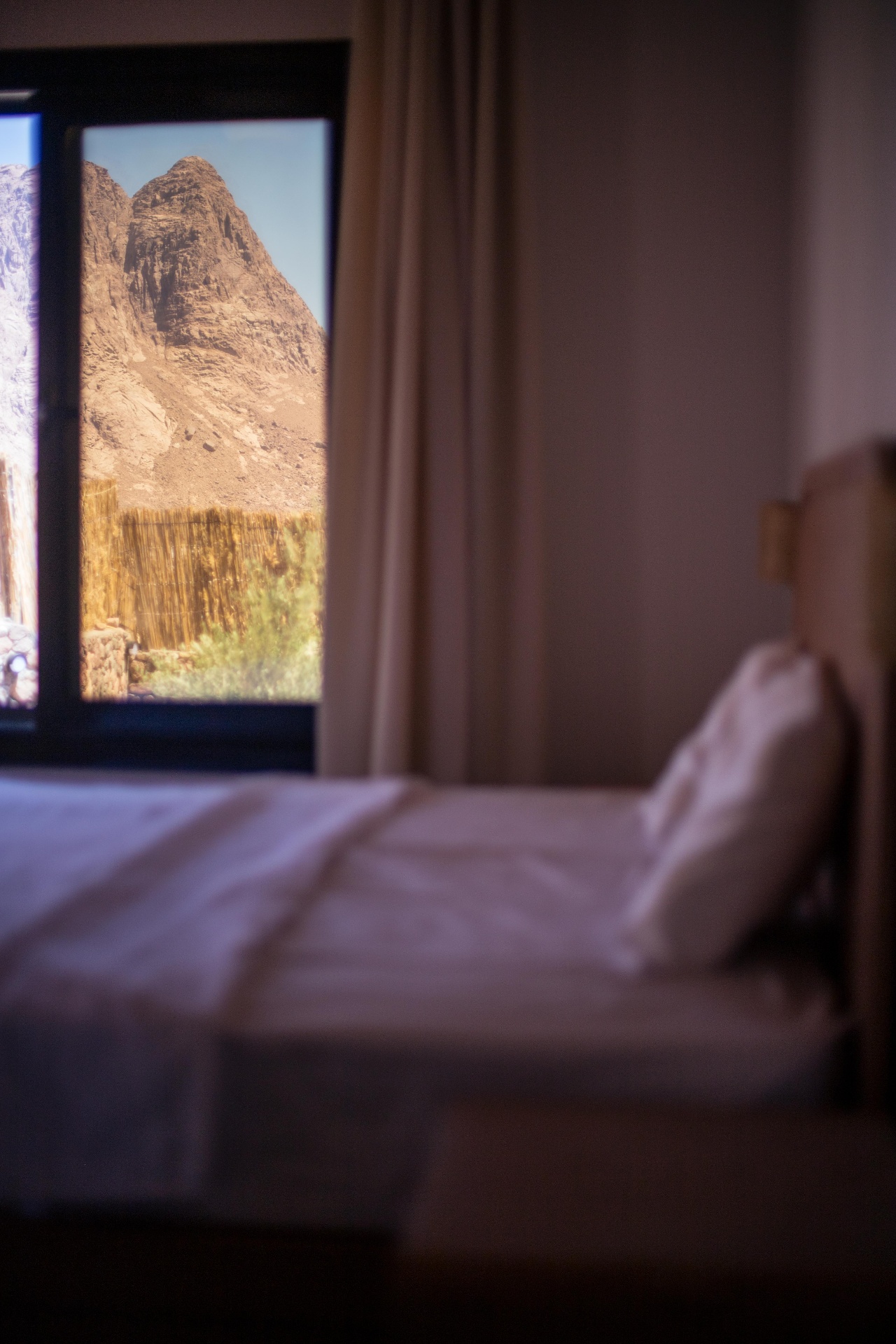Bedroom with mountain view through large window